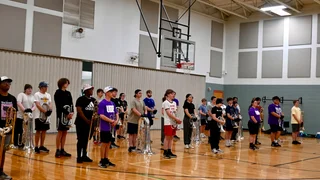Gems brass rehearsing during visual block at April camp.